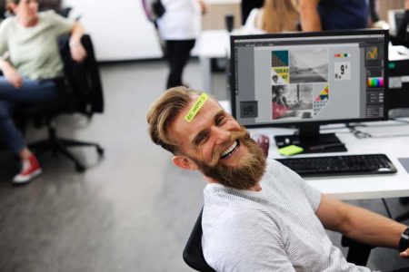 Bearded man in office smiling